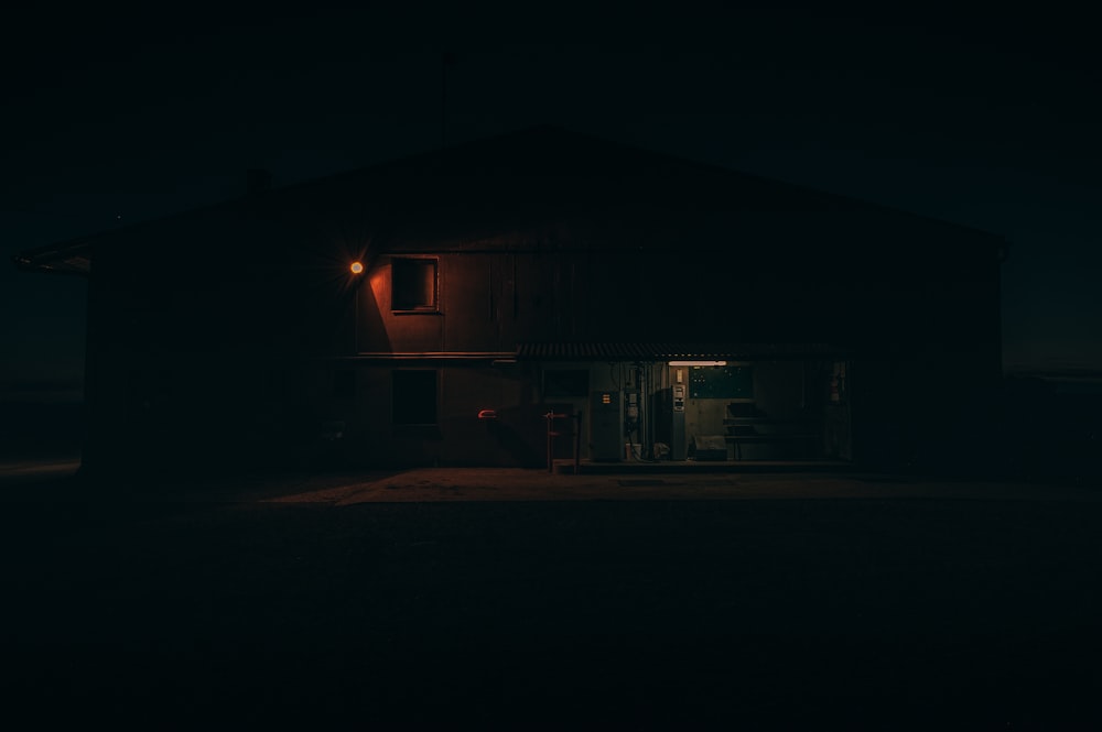 a dark house with a light on at night