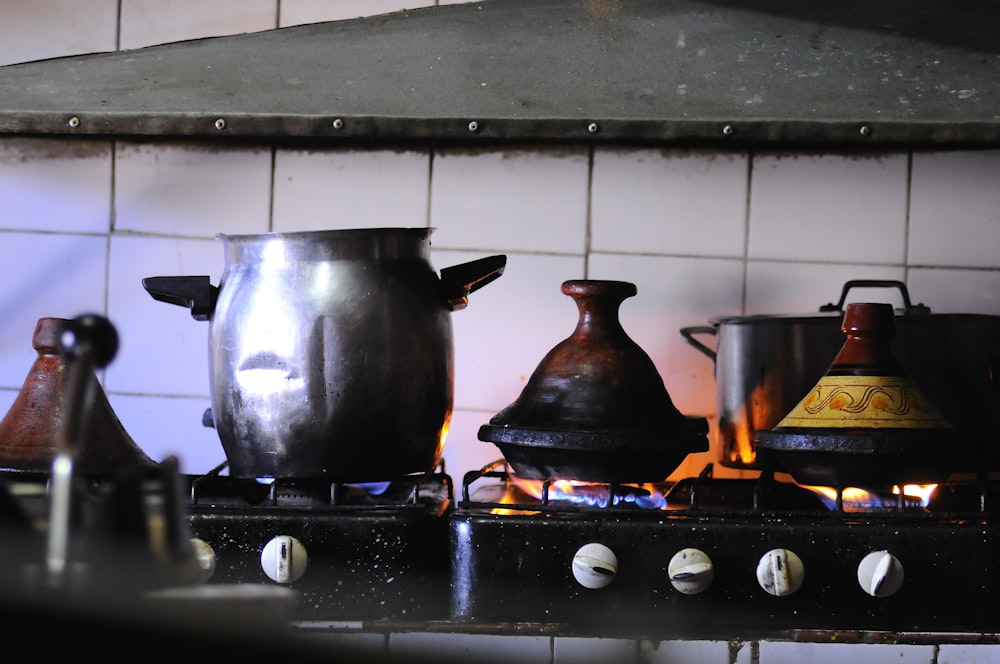 stainless steel cooking pot on black stove