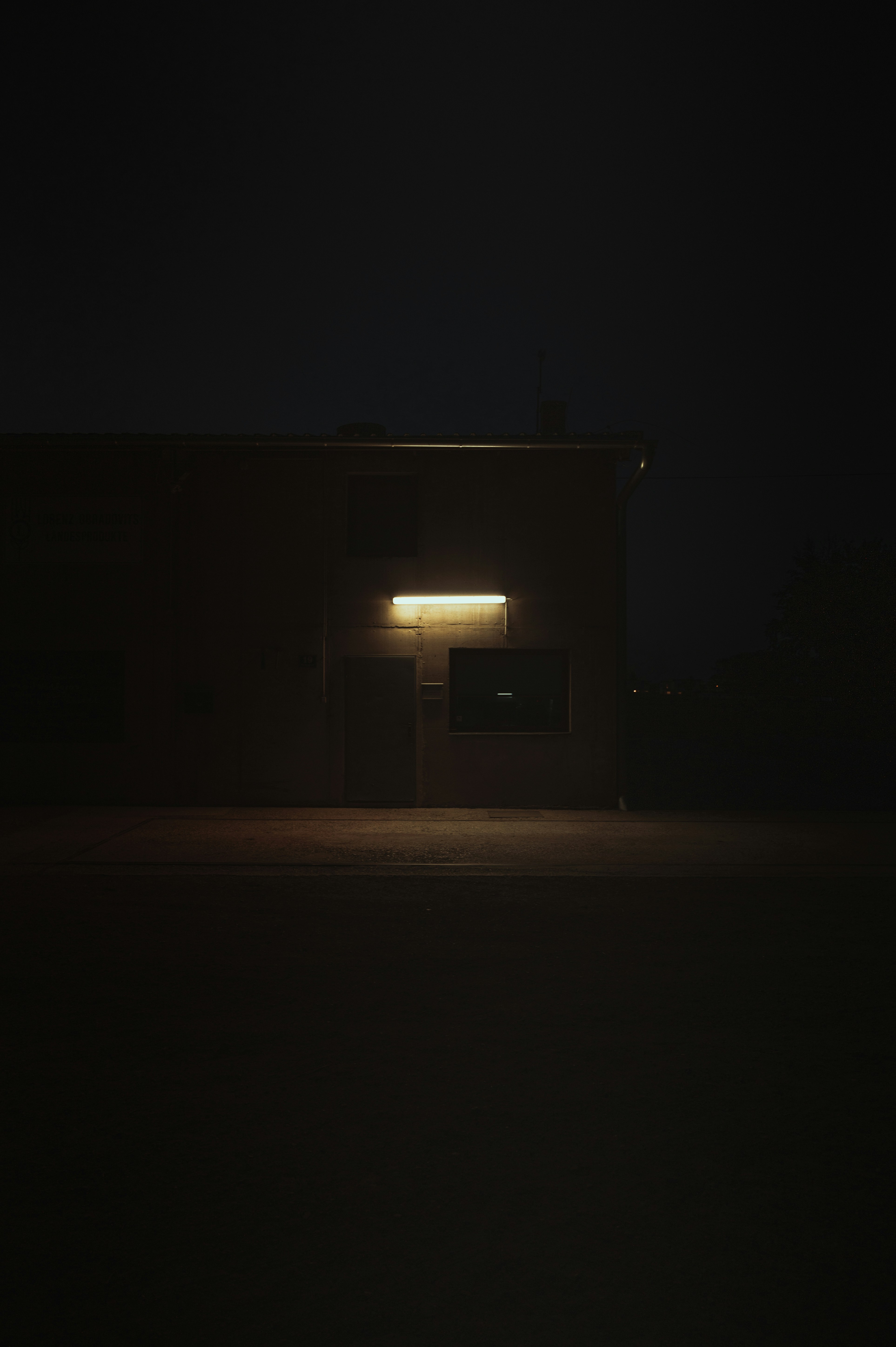 a building lit up at night with the light on