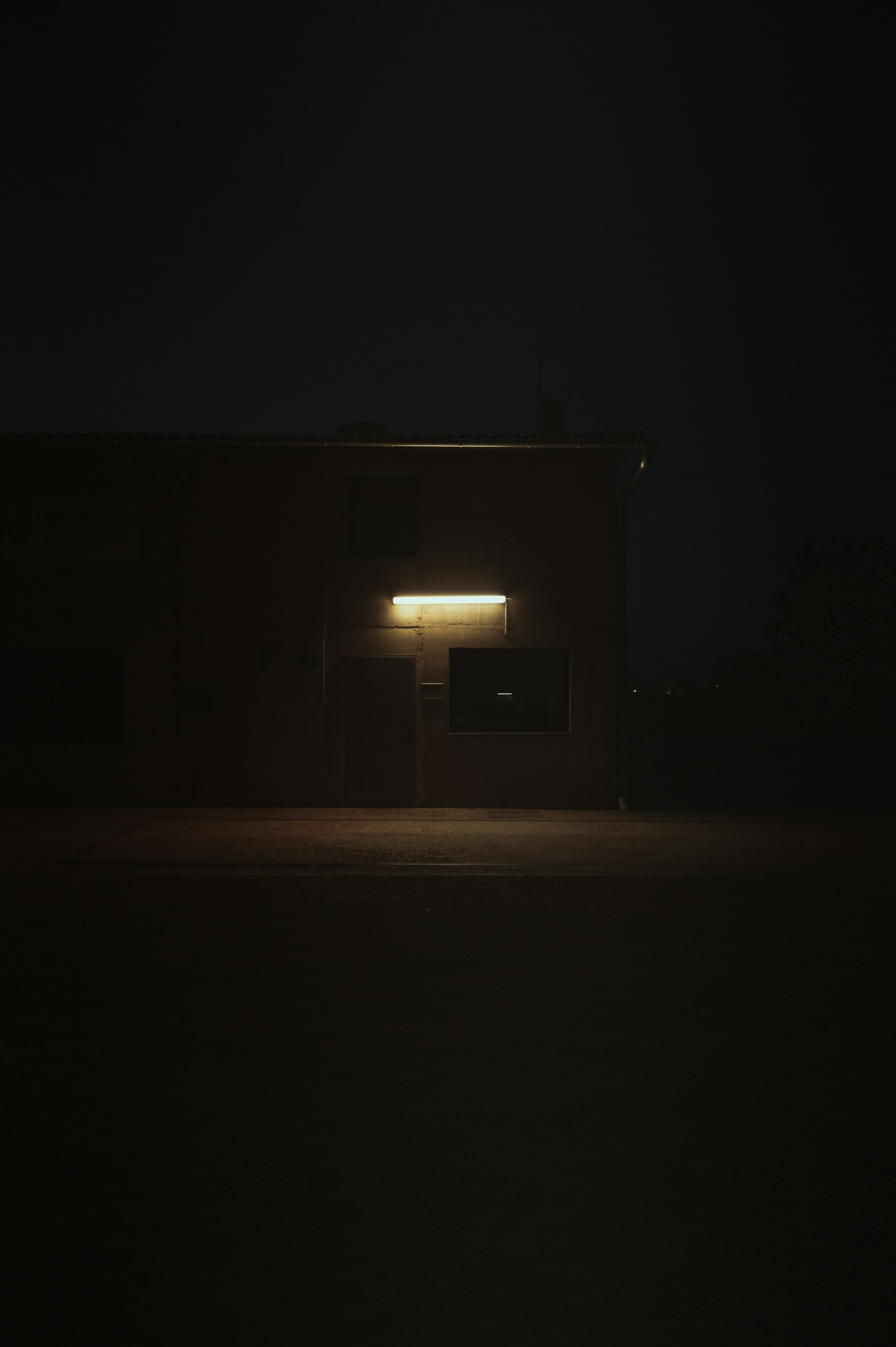a building lit up at night with the light on