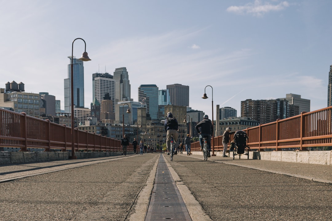 people passing by a street leading to the city, Stone Arch Bridge View Of Minneapolis Skyline