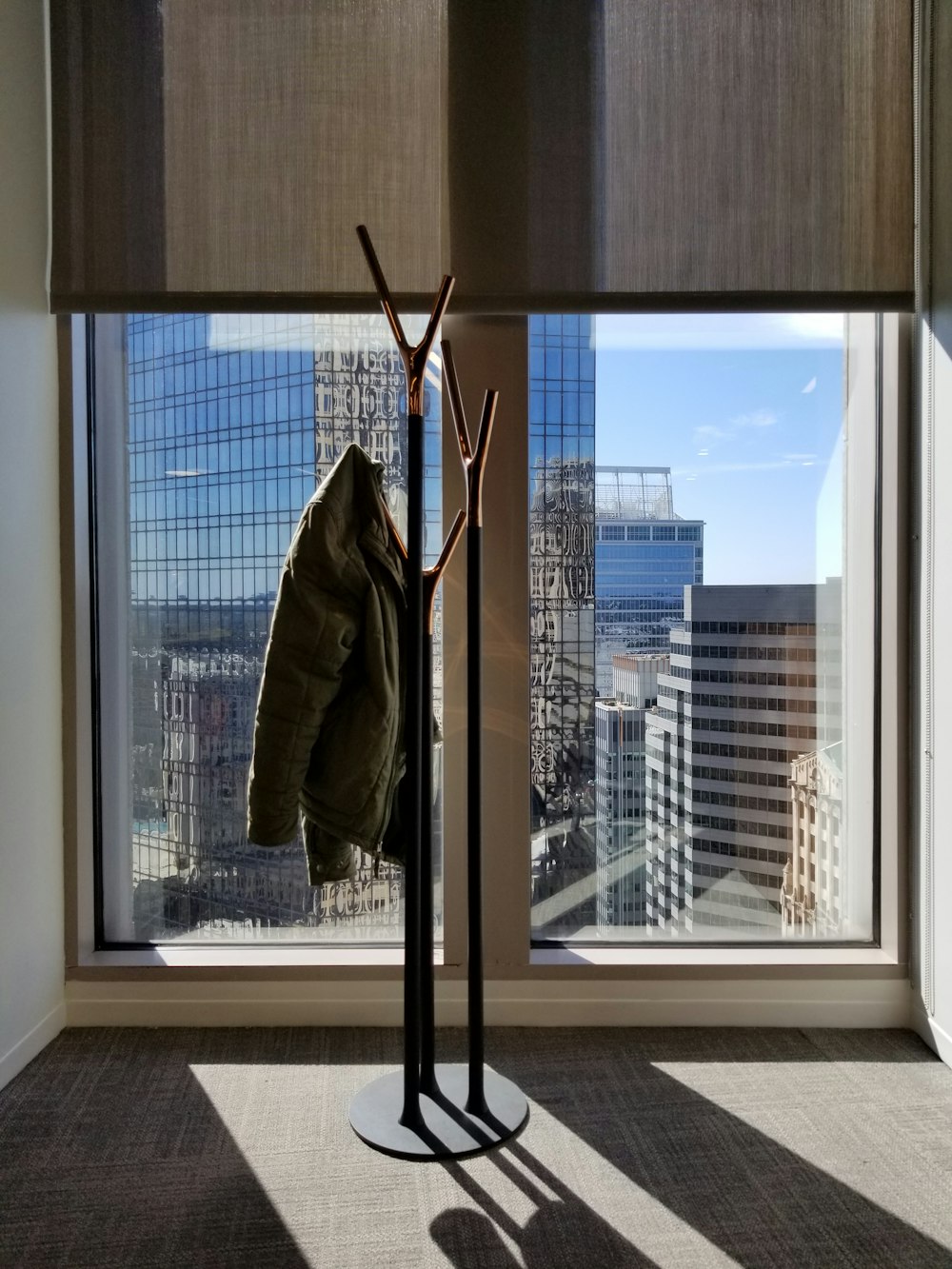 green jacket on a coat rack