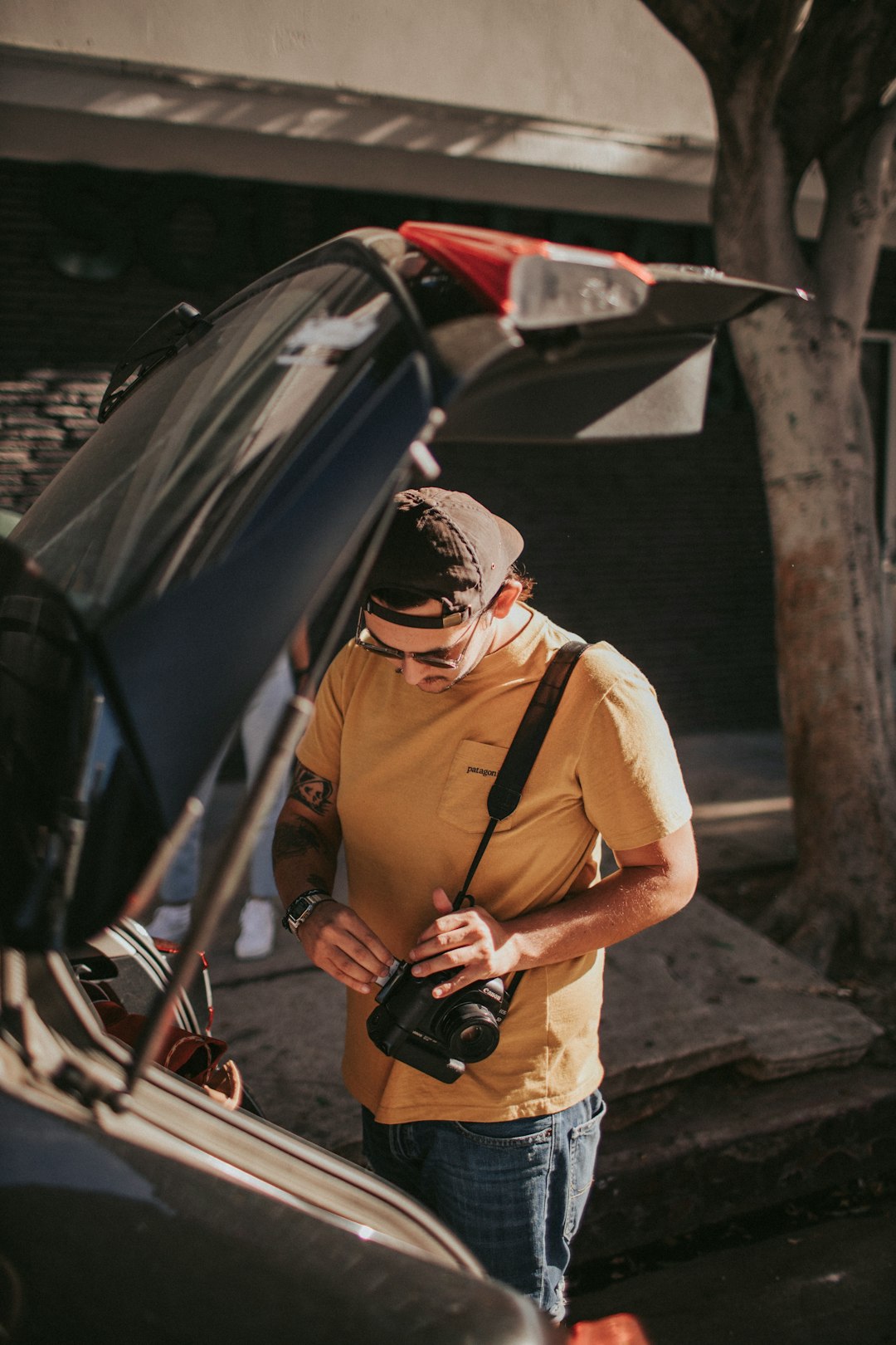 man standing behind a vehicle with an open trunk