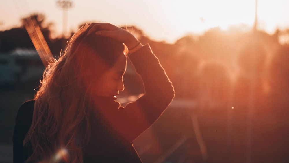 silhouette of woman holding head