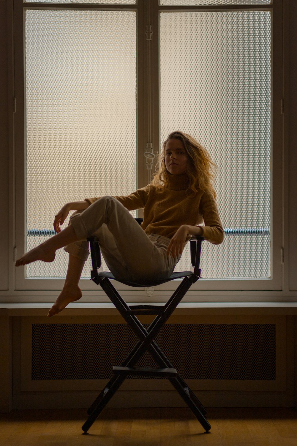 woman sitting on a wooden chair