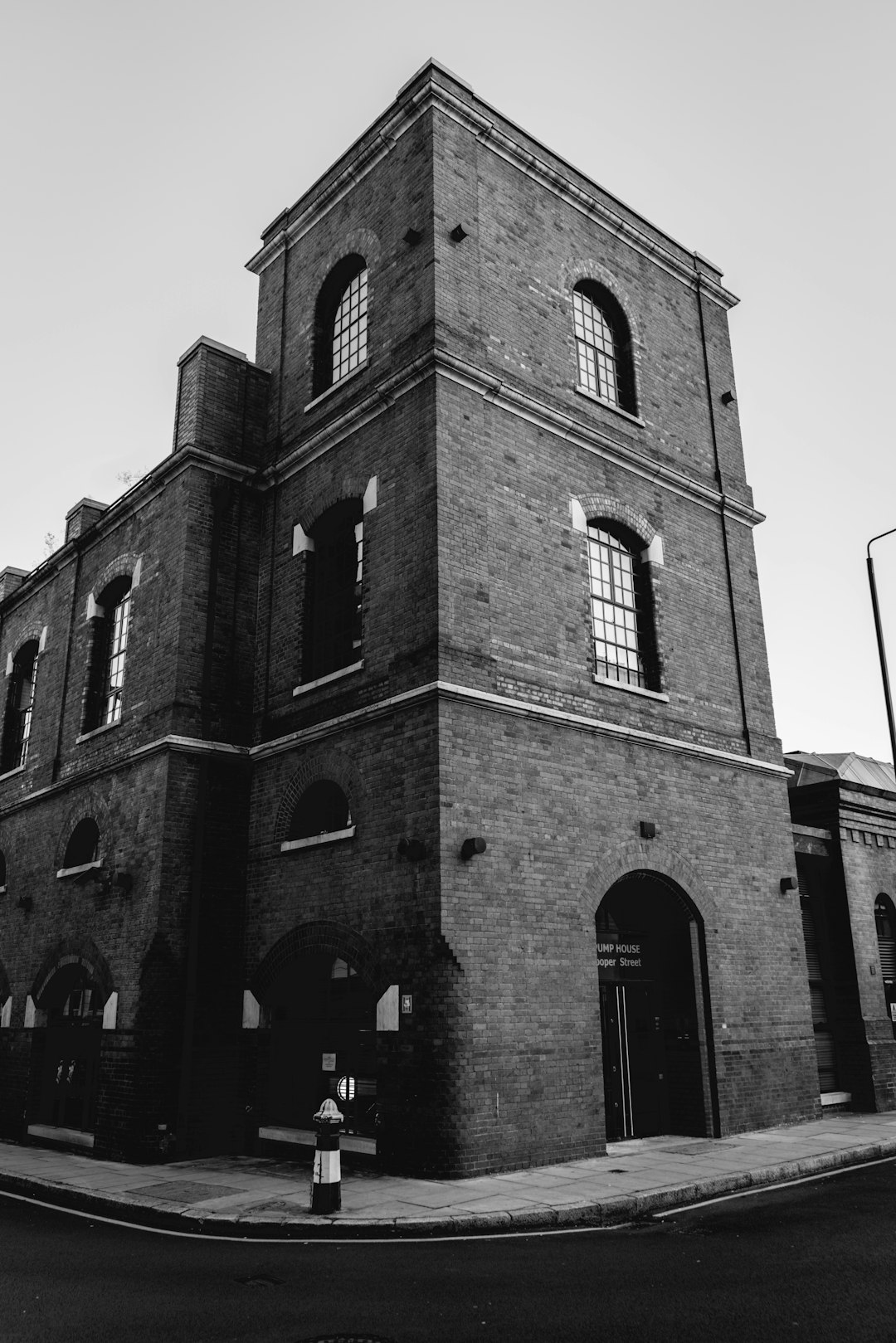 grayscale photo of brick building