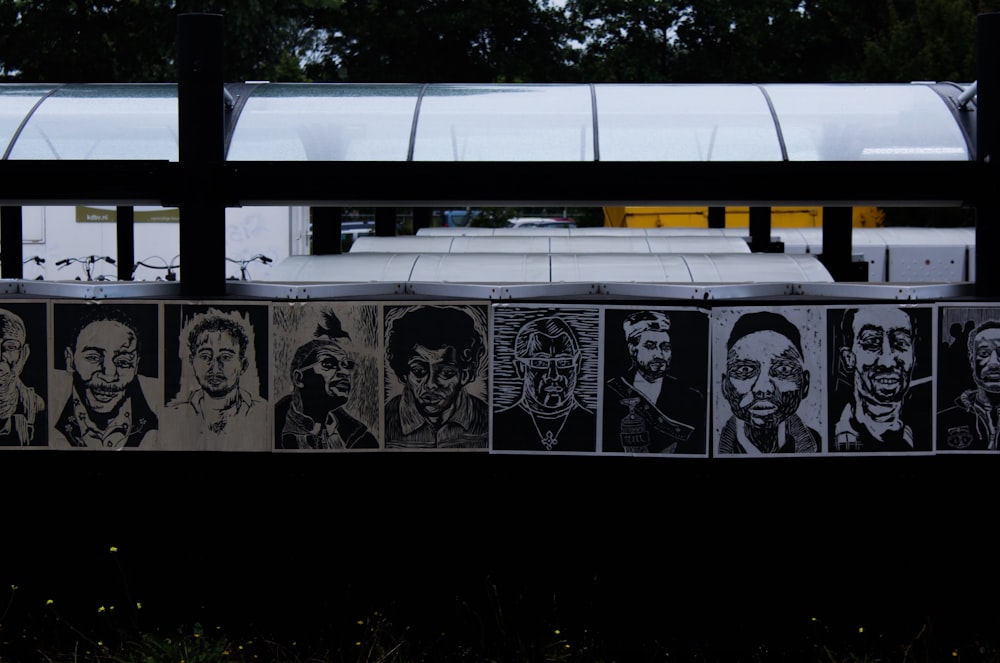 portrait sketches of men displayed on wall