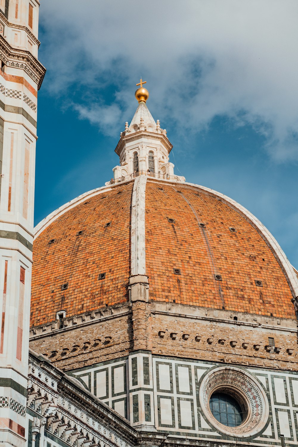 brown, white, and orange bricked cathedral