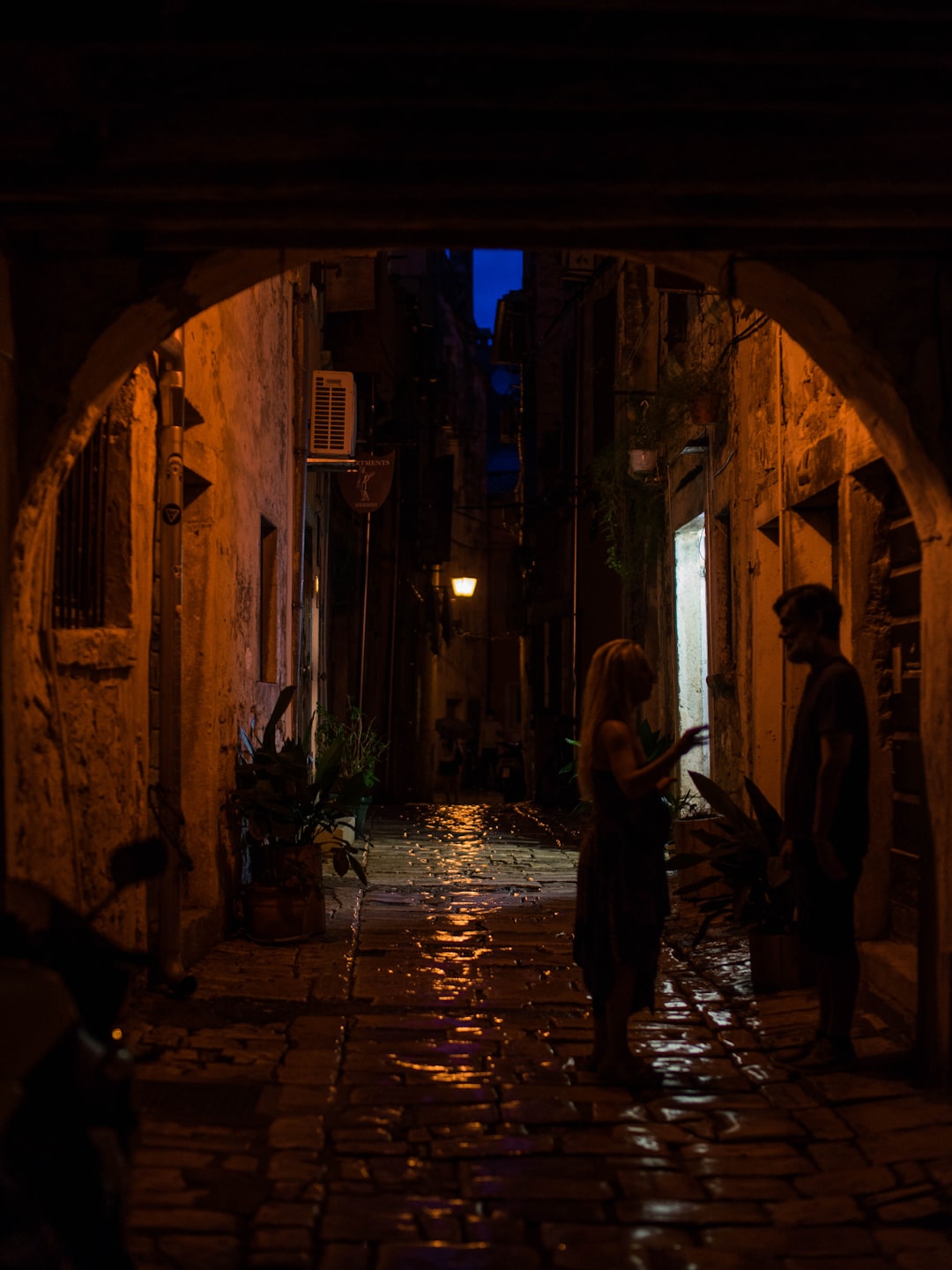 man and woman at an alley at night