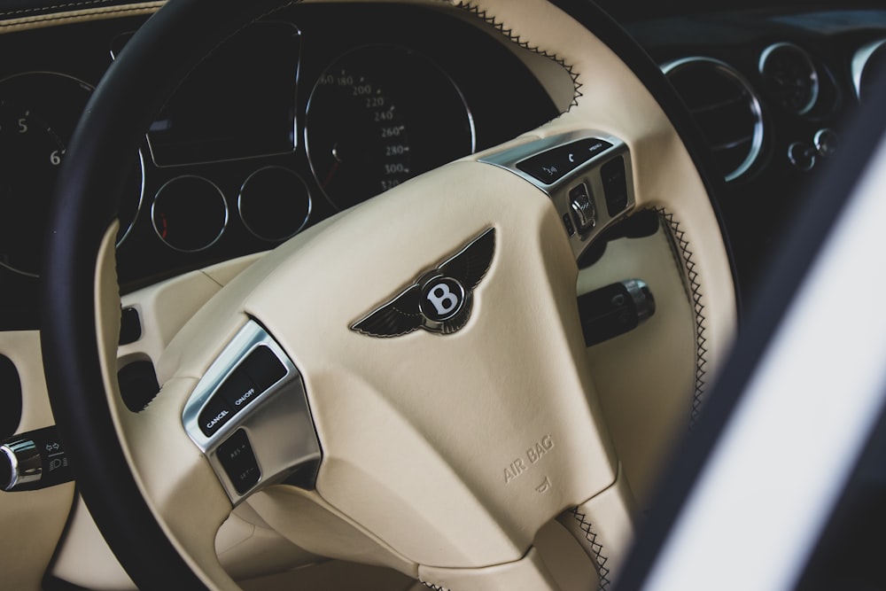 beige and black Bentley car steering wheel