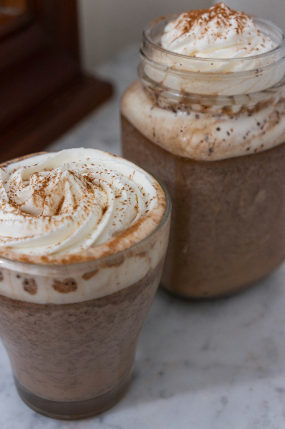 shallow focus photo of dessert in clear glass jar