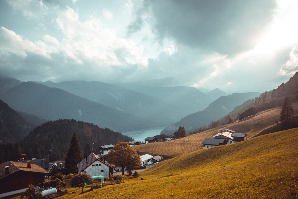 cabins on mountain under cloudy sky