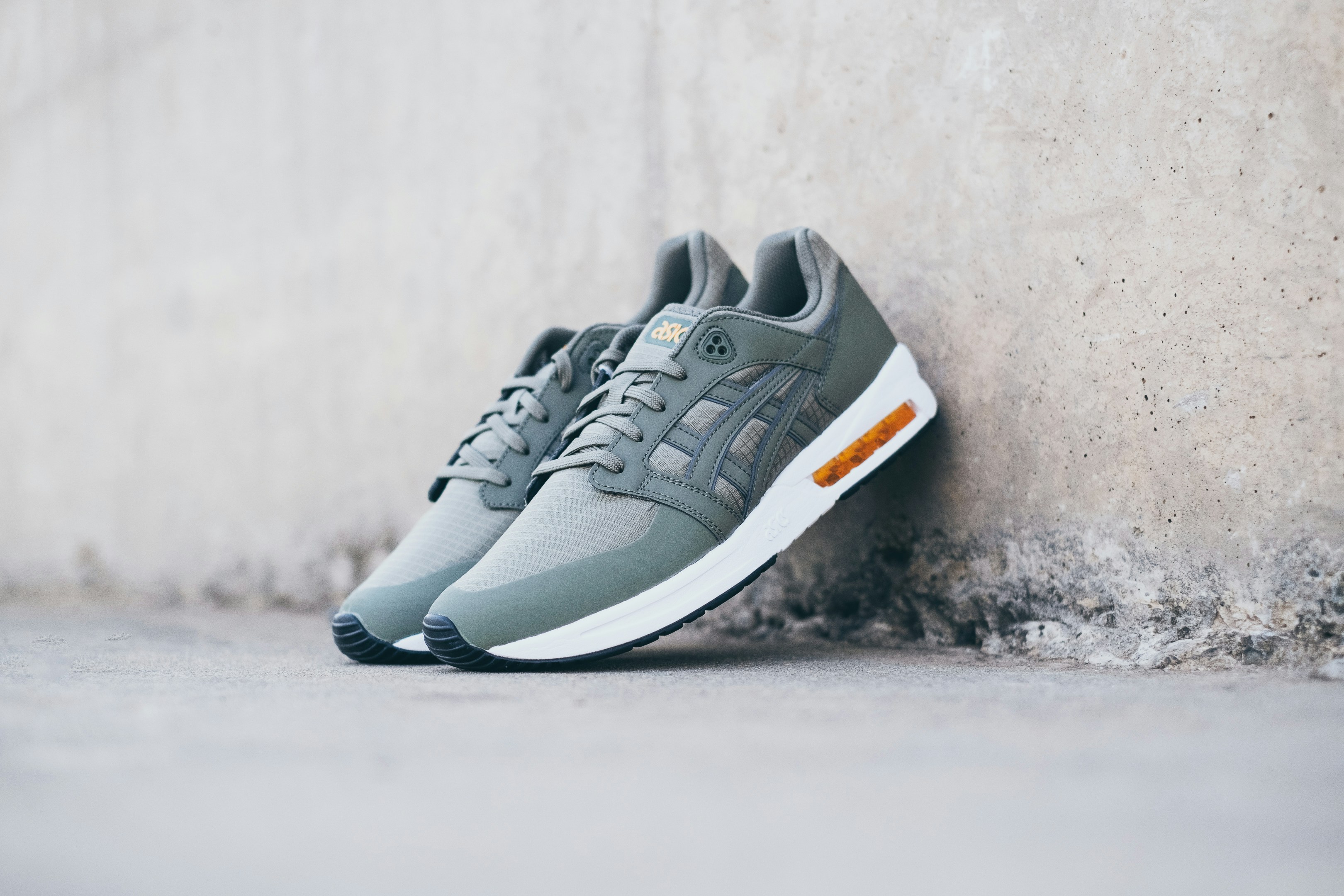 white-and-gray Asics low-top sneakers