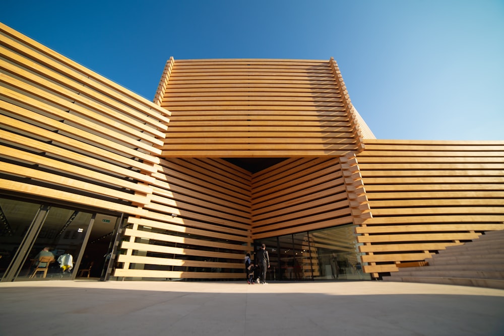 low-angle photography of yellow concrete building under a calm blue sky