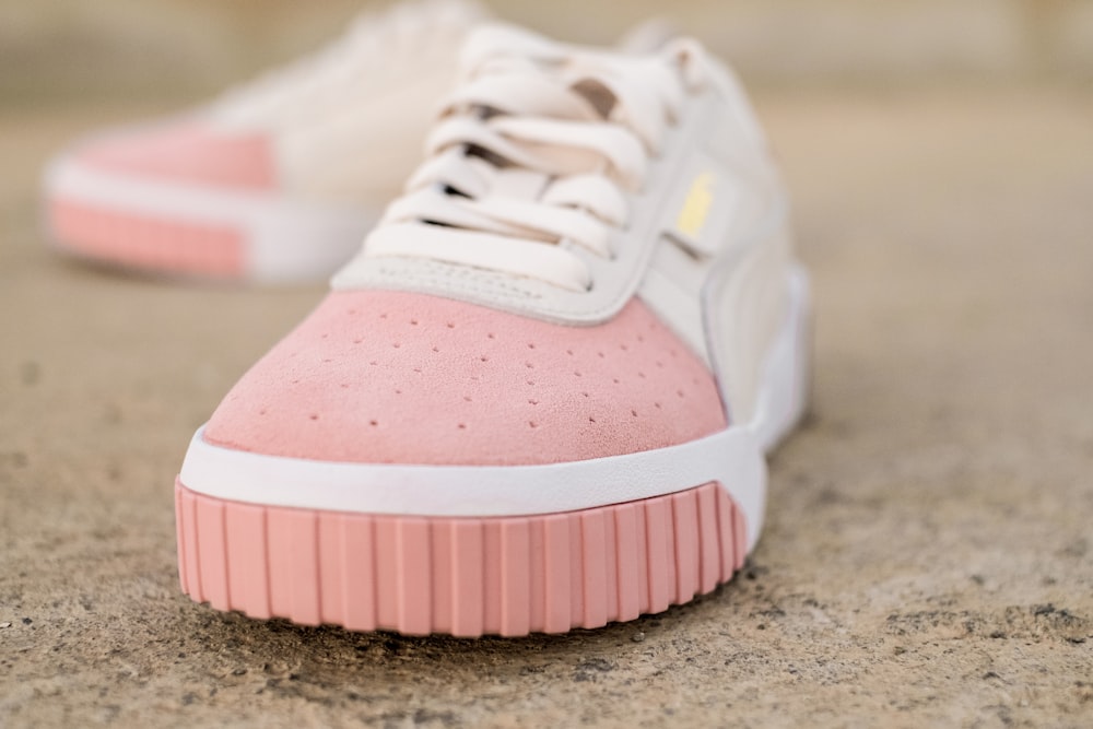 white-and-pink low-top sneakers