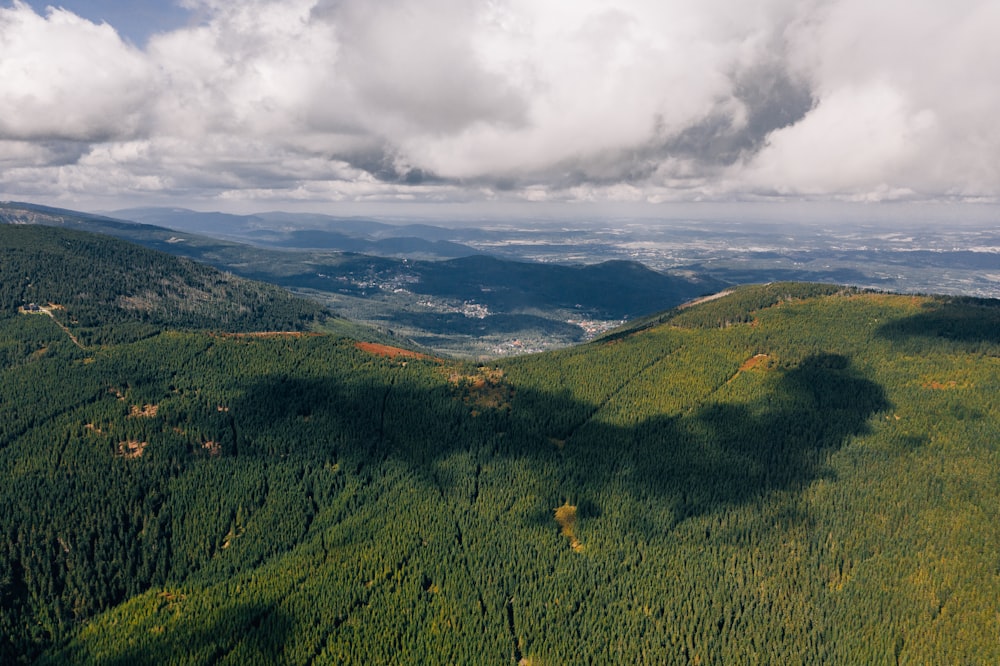 green mountains under cloudy sky