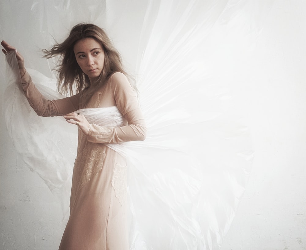 woman in beige long-sleeved dress