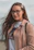 A smiling young woman with glasses, representing a happy university student user.