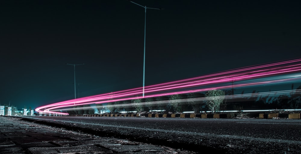 time lapse photography of passing cars in the street during nighttime