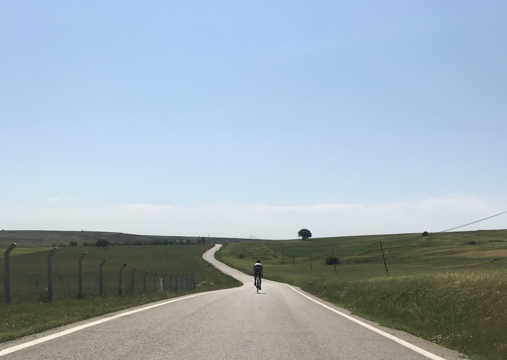 person riding bicycle in the road