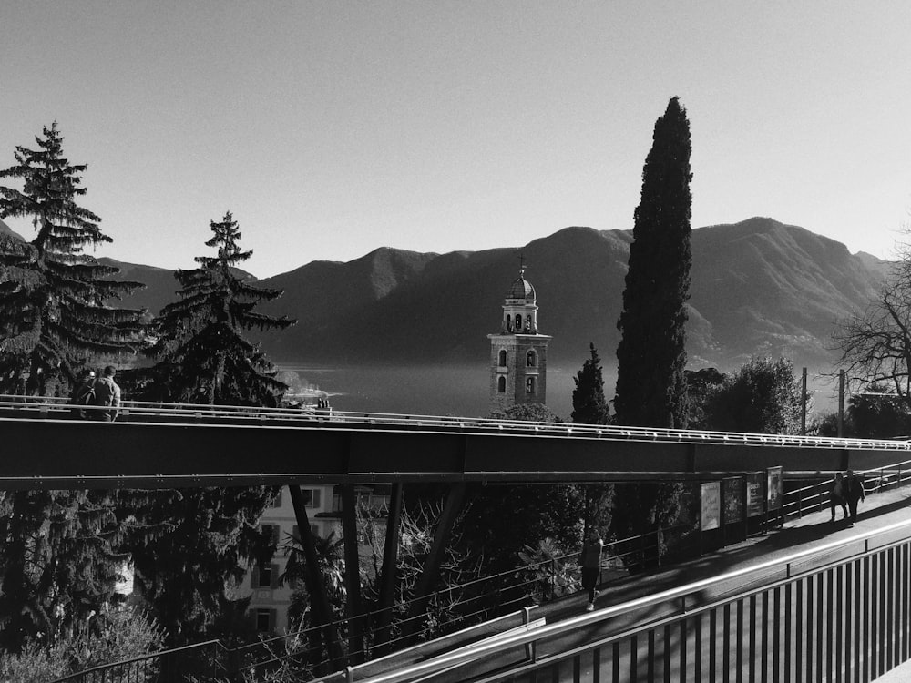 grayscale photo of mountains near body of water