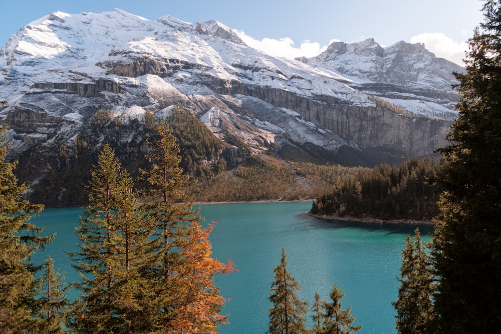 snow covered mountain near body of water