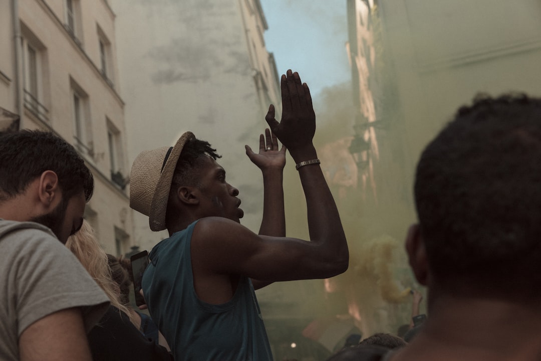 man raising both hands