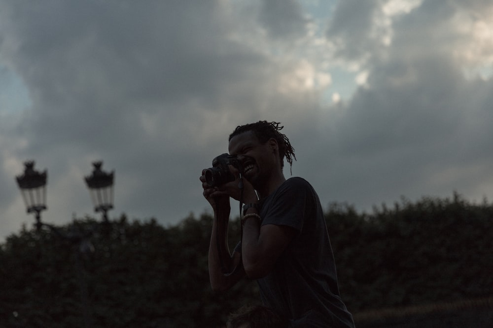 man standing under a cloudy sky