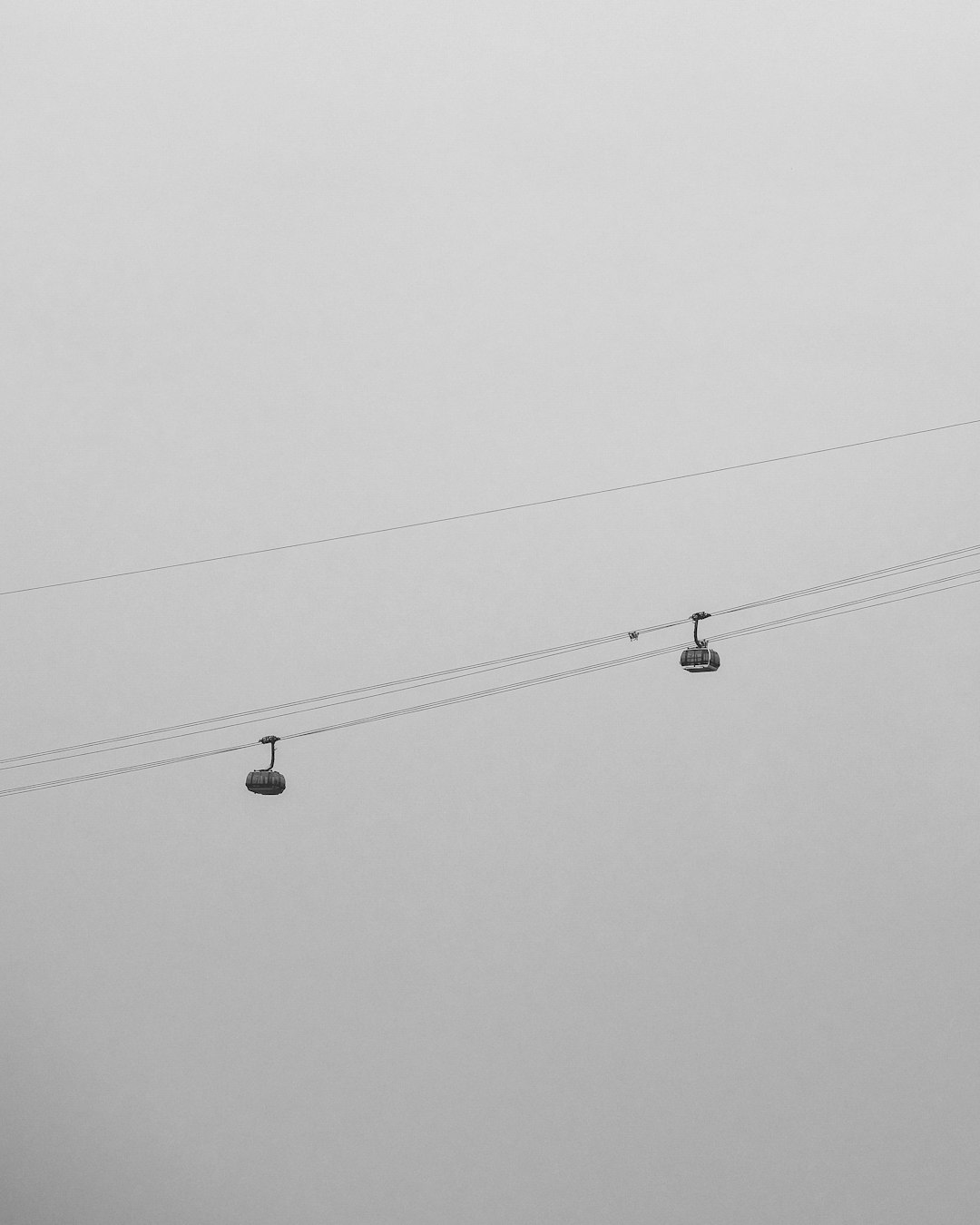 grayscale photography of cable cars