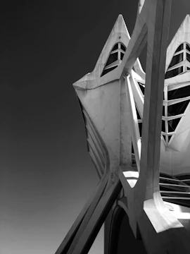 A 3D architectural model rendered in black and copper tones, highlighting precise geometric forms.