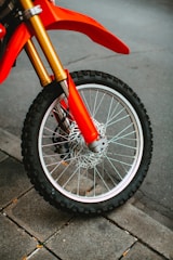 Close-up of a motorcycle tire being balanced on a wheel balancer.