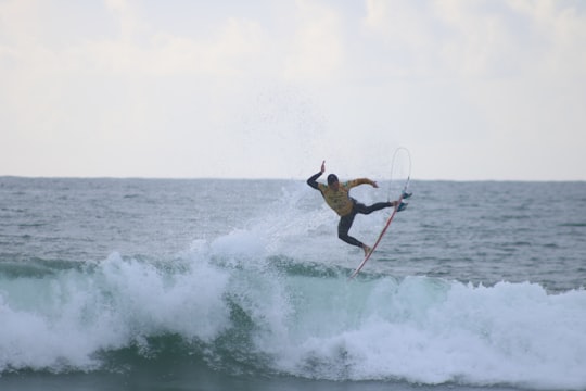 man surfing on sea in Peniche Portugal