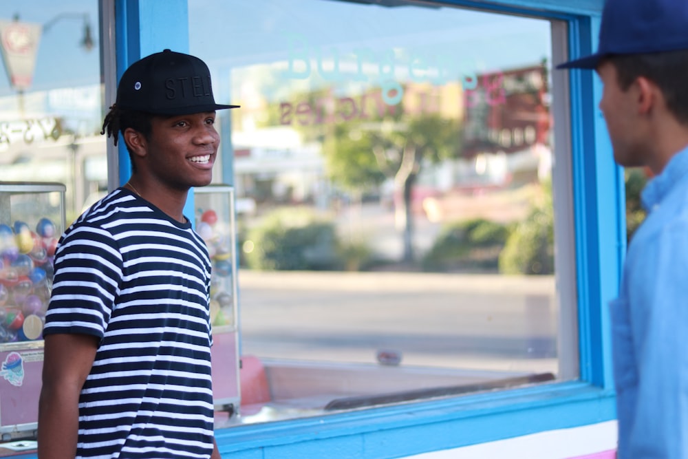 man leaning on glass window