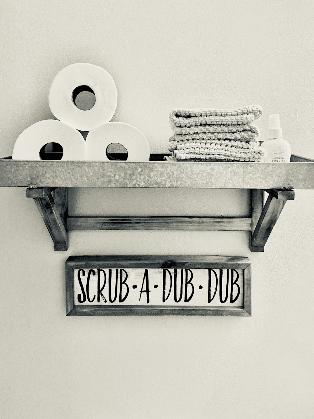 gray metal shelf with toilets and towel