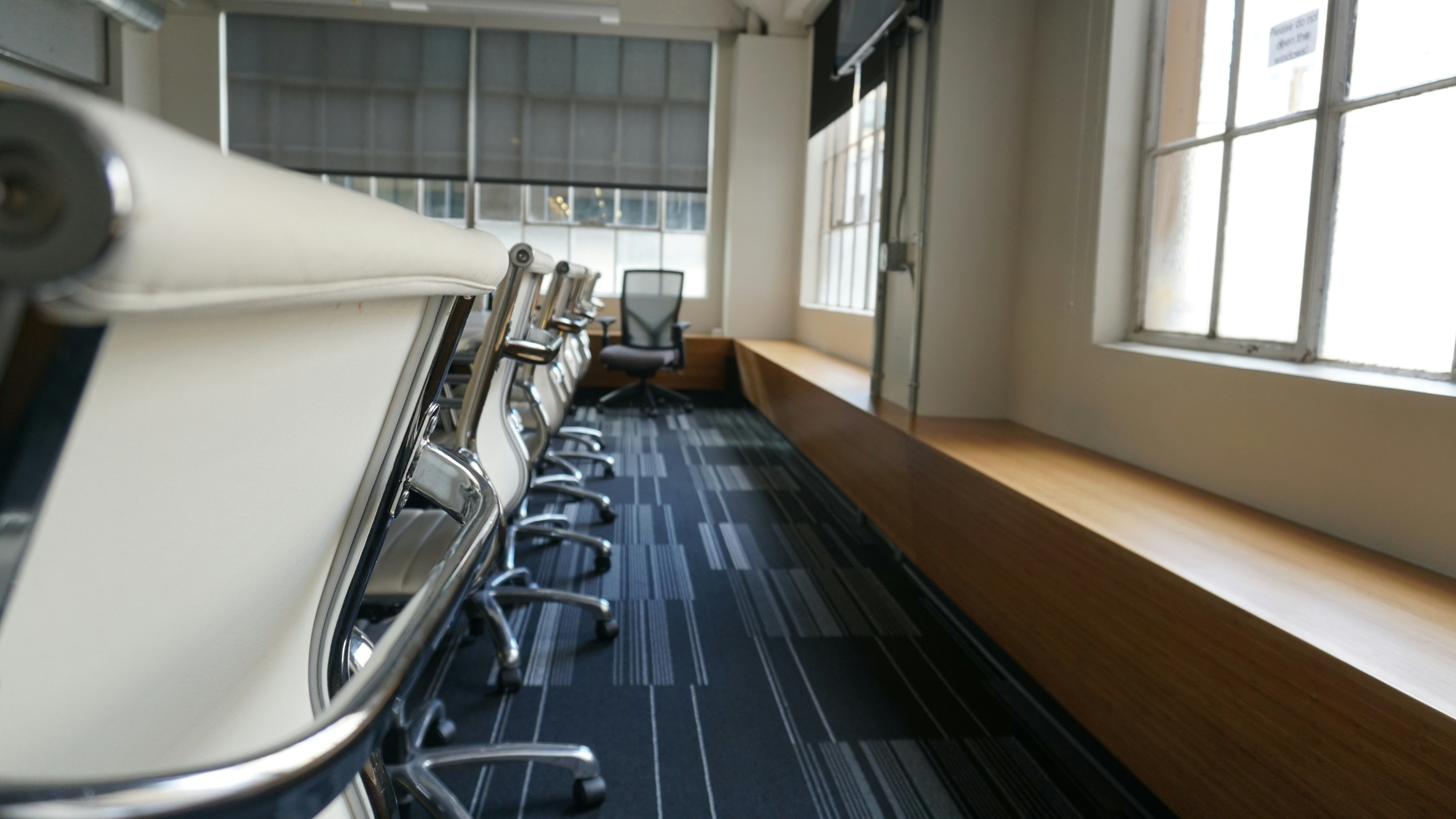 Professional corporate office interior, conference room with large windows, clean modern design, bright natural light