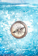 Close-up of a diver practicing underwater navigation with a compass.