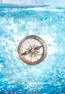 round gold-colored compass