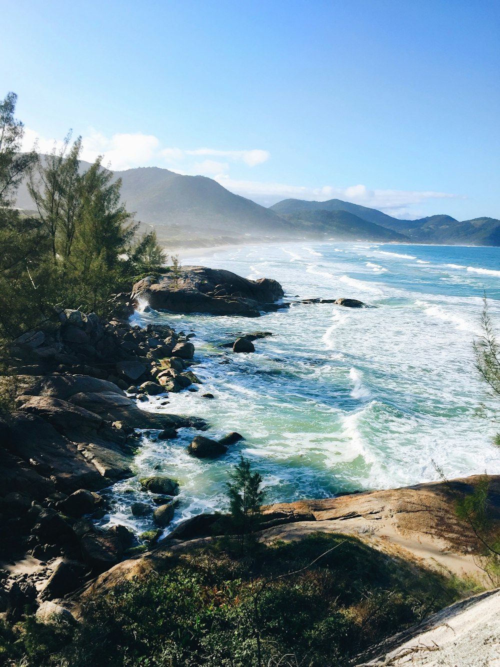 photo of seashore and mountain scenery