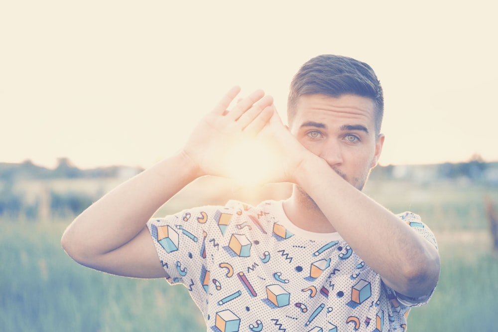 photo of man wearing white and blue crew-neck shirt