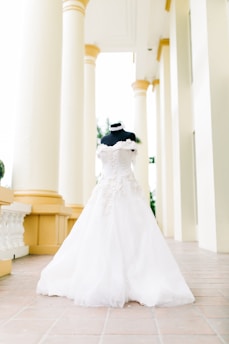 A beautifully redesigned wedding dress displayed on a mannequin in a cozy studio.