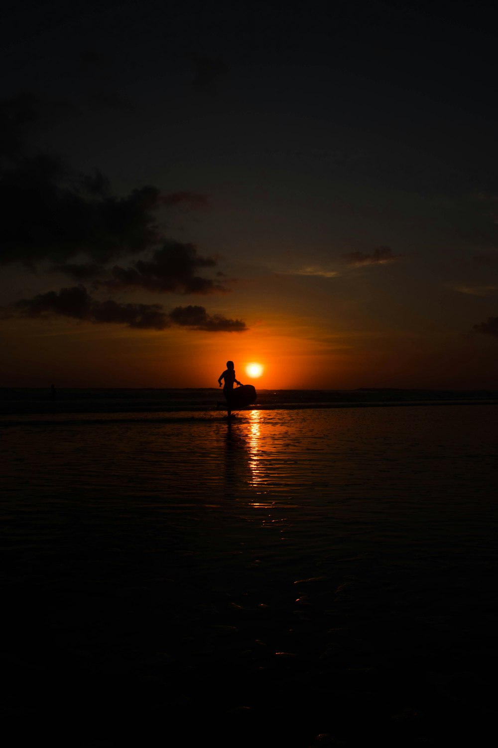 silhouette of person riding boat