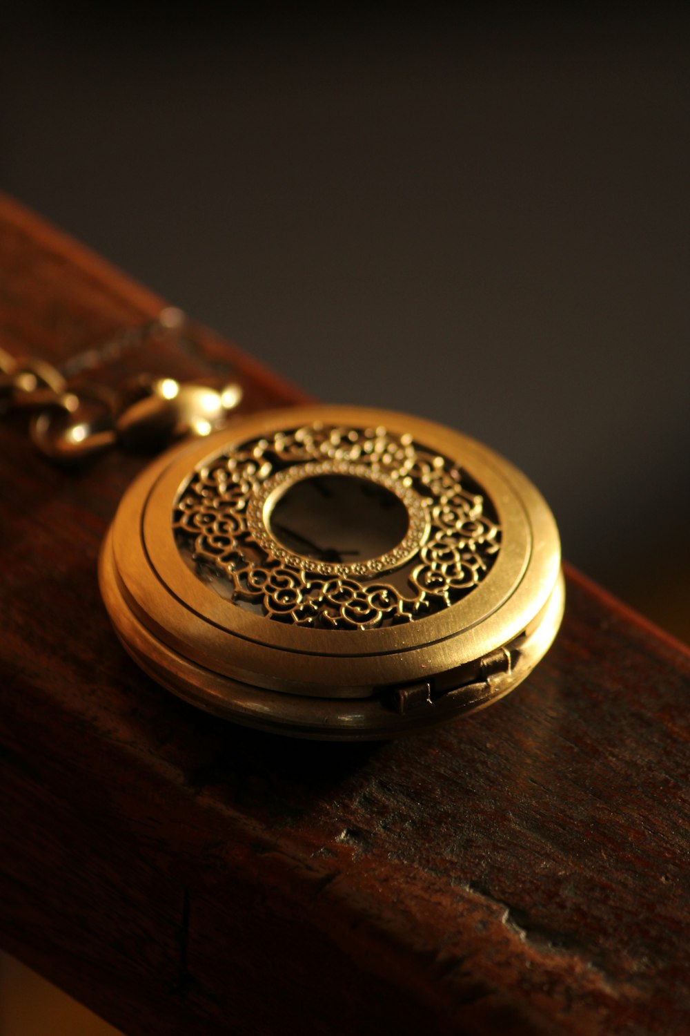 round gold-colored pocket watch