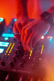 DJ mixing music live with colorful lights creating a lively atmosphere at a Bogotá event.