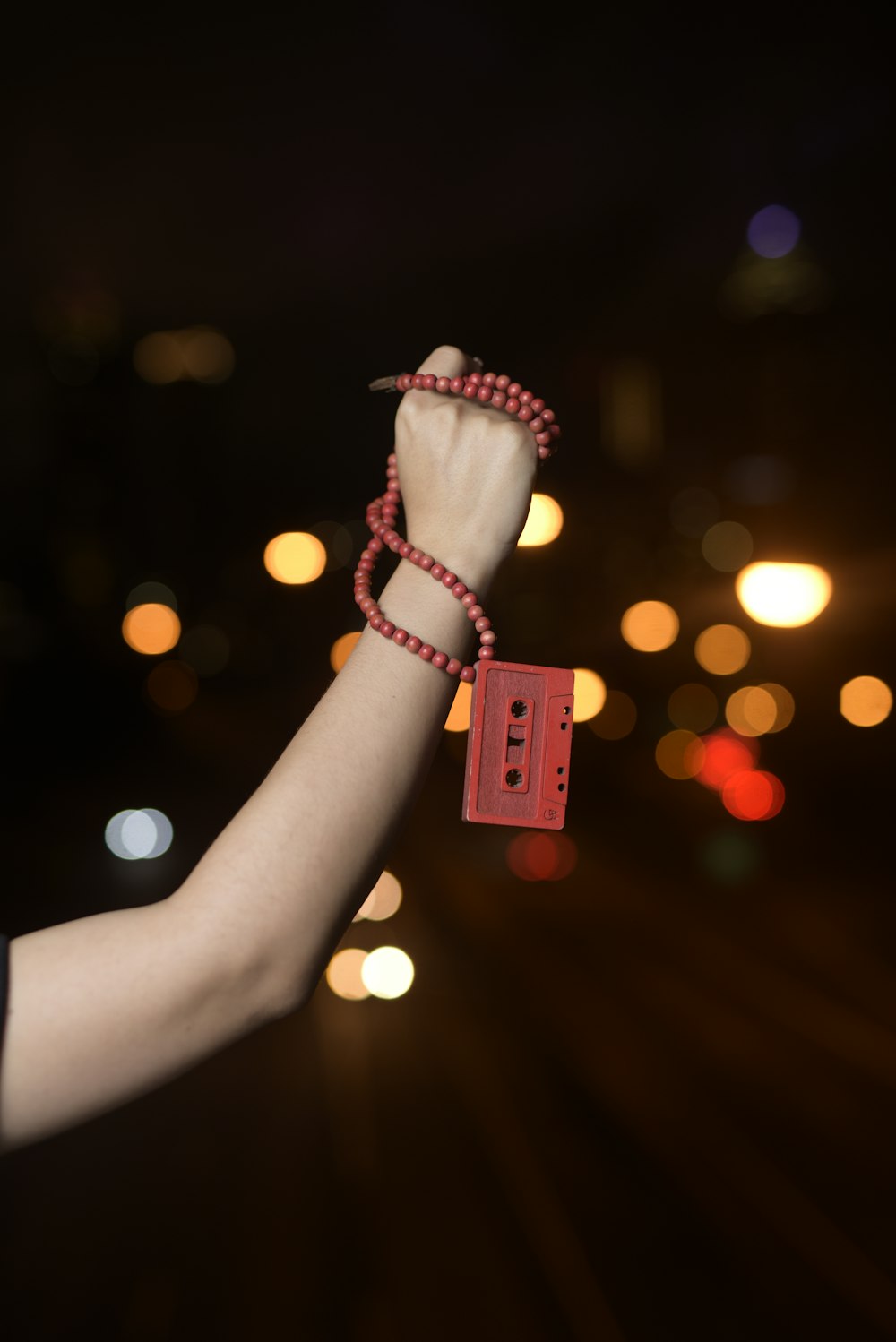 a person holding a red string with a red tag on it