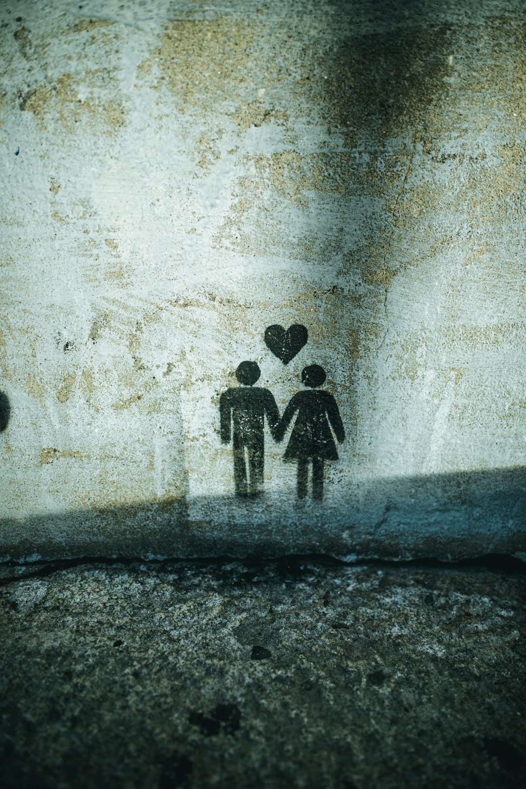 couple holding hands painting on wall