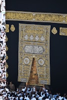 Group of travelers preparing their ihram clothing for the pilgrimage.