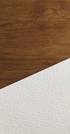 white paper on brown wooden surface