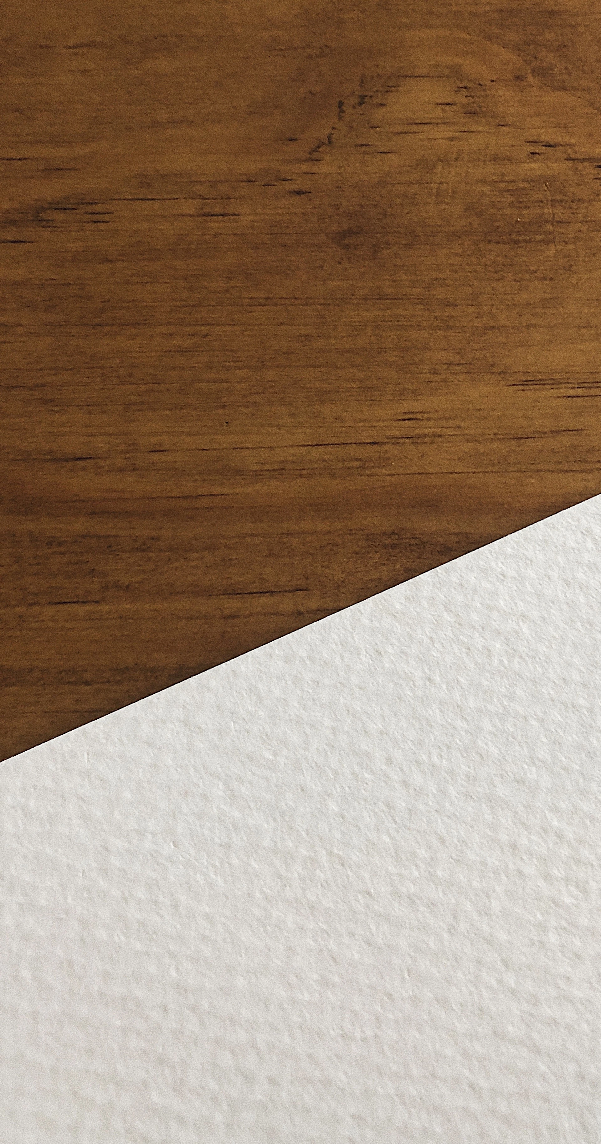 white paper on brown wooden surface
