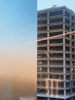 Evening photo of a bank building under construction with lights illuminating the structure.