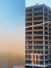 Golden-lit commercial building under construction at dusk.
